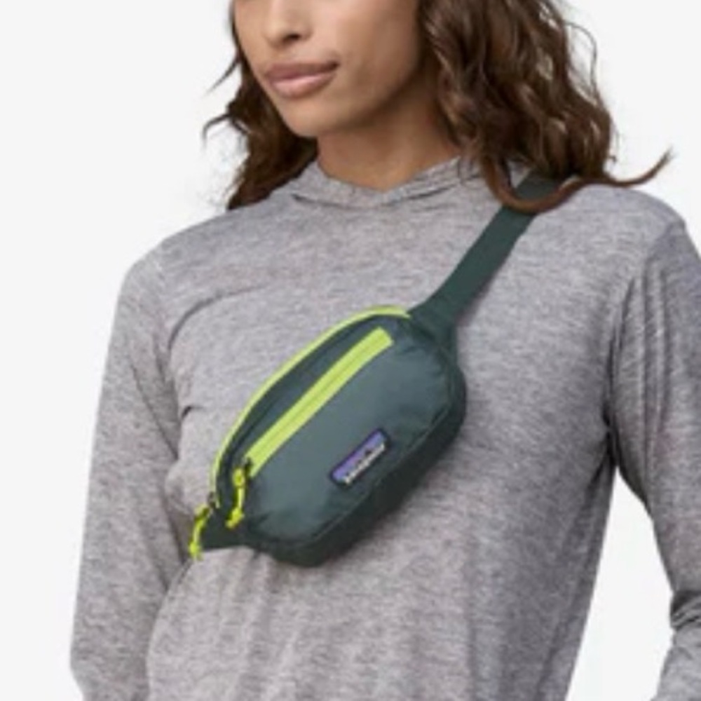 Patagonia green waist pack with neon yellow zipper